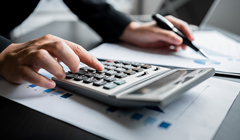 Person calculating their latest tax returns