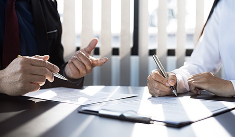 two people in an office discussing trade credit insurance solutions
