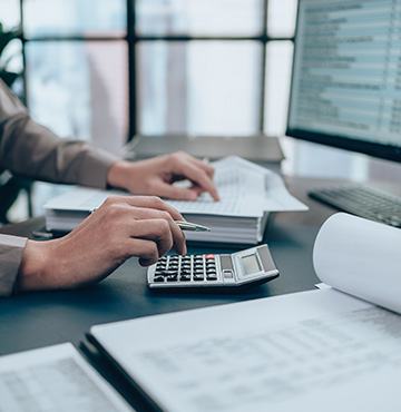 person calculating business finances at their desk