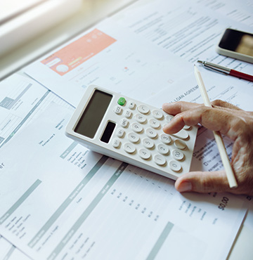 person with calculator, invoice financing